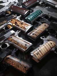 Custom 1911 pistol with mammoth tusk ivory and stabilized mammoth tooth grips