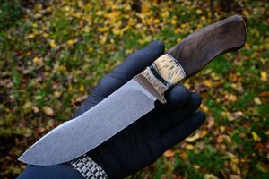 Mammoth tusk inlay knife with fossil handle material, showcasing natural prehistoric patterns and rich earthy tones, crafted for custom knifemaking and collectors