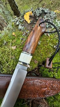 Mammoth tooth inlay knife with stabilized fossil handle material, showcasing natural prehistoric patterns and rich earthy tones, crafted for custom knifemaking and collectors