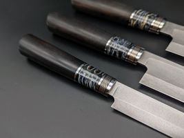 Mammoth tooth inlay knife with stabilized fossil handle material, showcasing natural prehistoric patterns and rich earthy tones, crafted for custom knifemaking and collectors