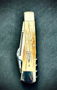 Mammoth tusk bark inlay knife with fossil handle material, showcasing natural prehistoric patterns and rich earthy tones, crafted for custom knifemaking and collectors