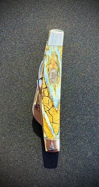 Mammoth tooth inlay knife with stabilized fossil handle material, showcasing natural prehistoric patterns and rich earthy tones, crafted for custom knifemaking and collectors