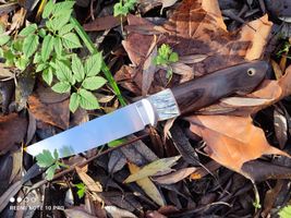 Mammoth tooth inlay knife with stabilized fossil handle material, showcasing natural prehistoric patterns and rich earthy tones, crafted for custom knifemaking and collectors