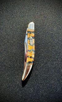 Mammoth tooth inlay knife with stabilized fossil handle material, showcasing natural prehistoric patterns and rich earthy tones, crafted for custom knifemaking and collectors