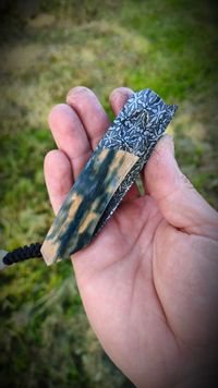 Mammoth tusk bark inlay knife with fossil handle material, showcasing natural prehistoric patterns and rich earthy tones, crafted for custom knifemaking and collectors