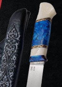 Mammoth tusk inlay knife with stabilized fossil handle material, showcasing natural prehistoric patterns and rich earthy tones, crafted for custom knifemaking and collectors