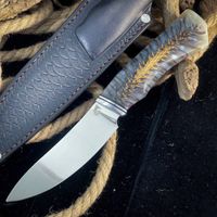 Knife with pinecone in resin handle, featuring a stabilized natural pinecone embedded in clear resin with intricate organic texture, ideal for custom knifemaking and unique handle designs