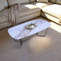 Voss rectangular coffee table with champagne gold brushed stainless steel legs and a white sintered stone top, styled in a modern living room with a beige sofa, neutral rug, and contemporary décor