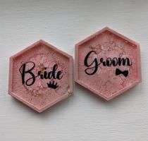 2 hexagonal coasters with a pink marbled design , personalised with the words Bride & groom