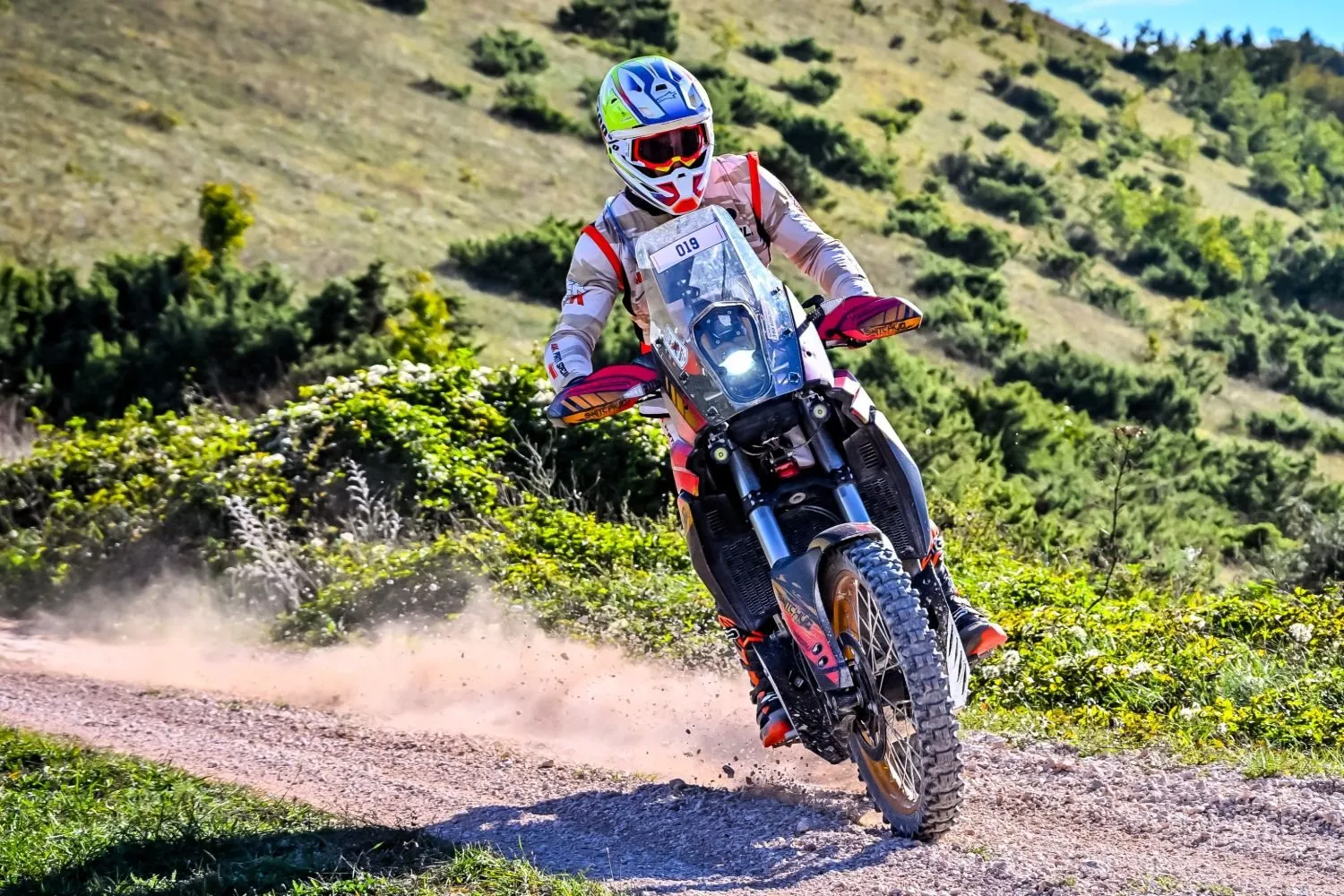 Pilota in azione su uno sterrato in collina, con moto allestita da 4K Parti Speciali