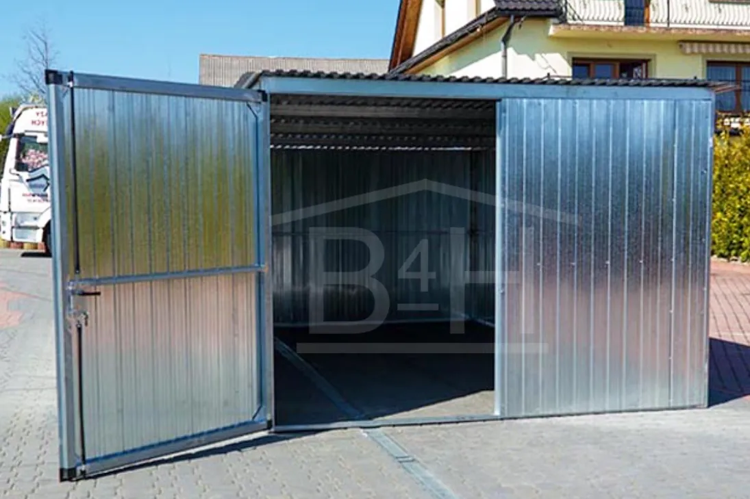Aerial view of blue train traveling through lush green mountain valley with misty hills