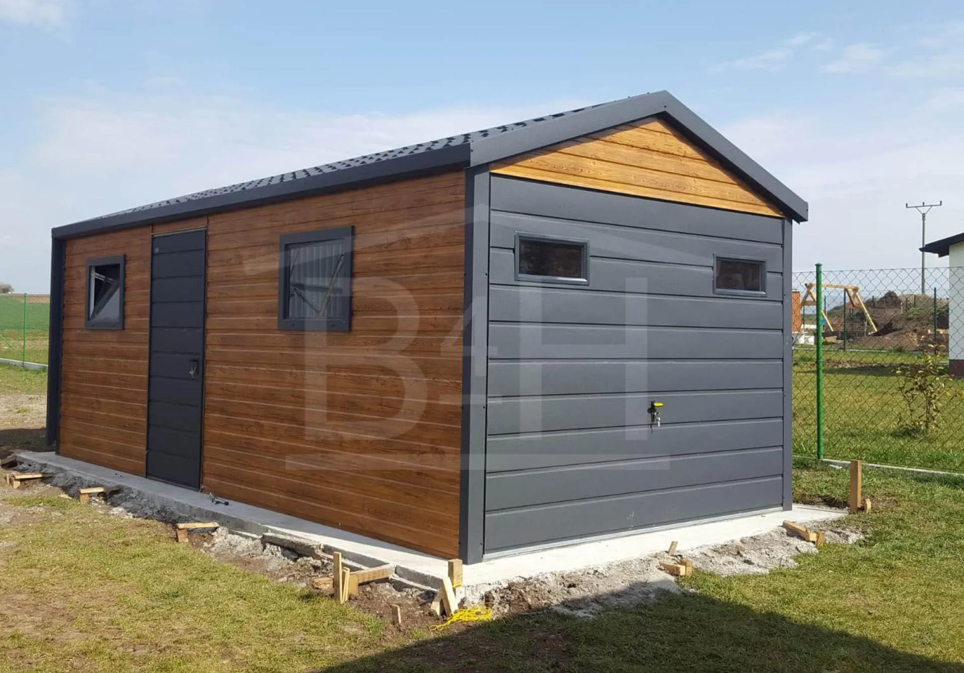 Silhouette of person standing on rock by the ocean during sunset, no facial features visible